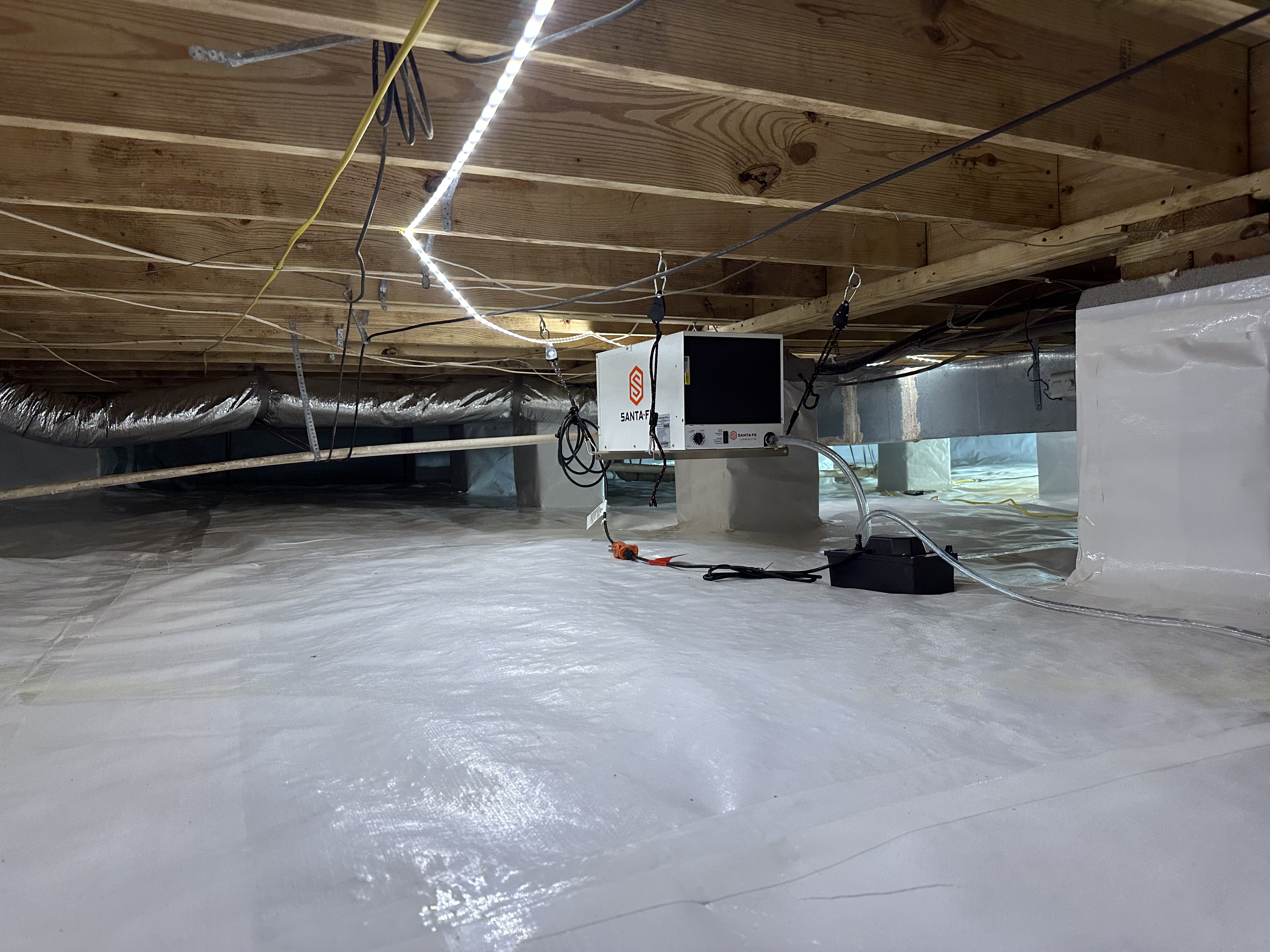 Completed crawlspace encapsulation with Santa-Fe dehumidifier and white vapor barrier liner, Chattanooga TN