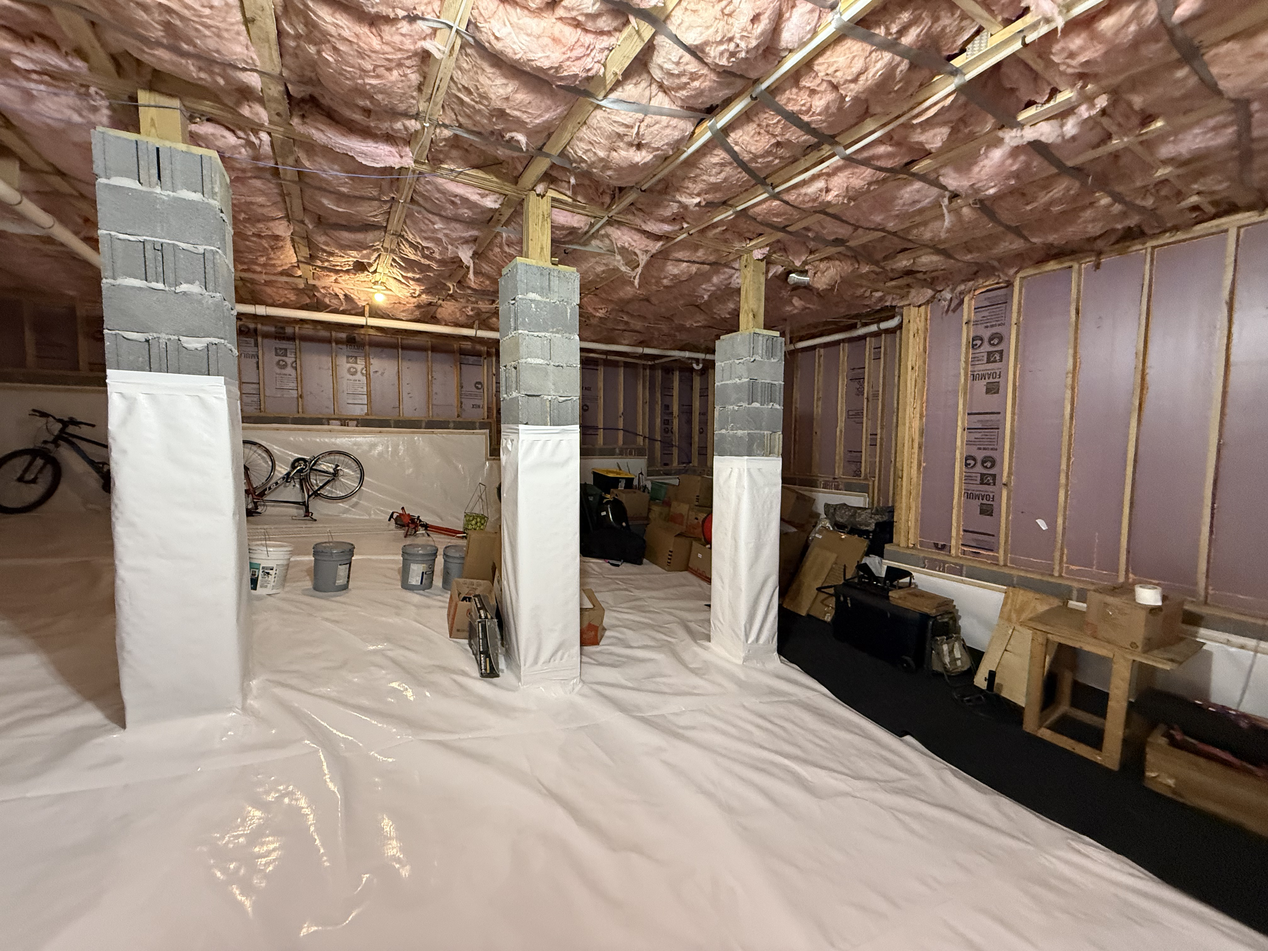 Crawlspace encapsulation with pink fiberglass insulation overhead and white vapor barrier walls, Hamilton County TN