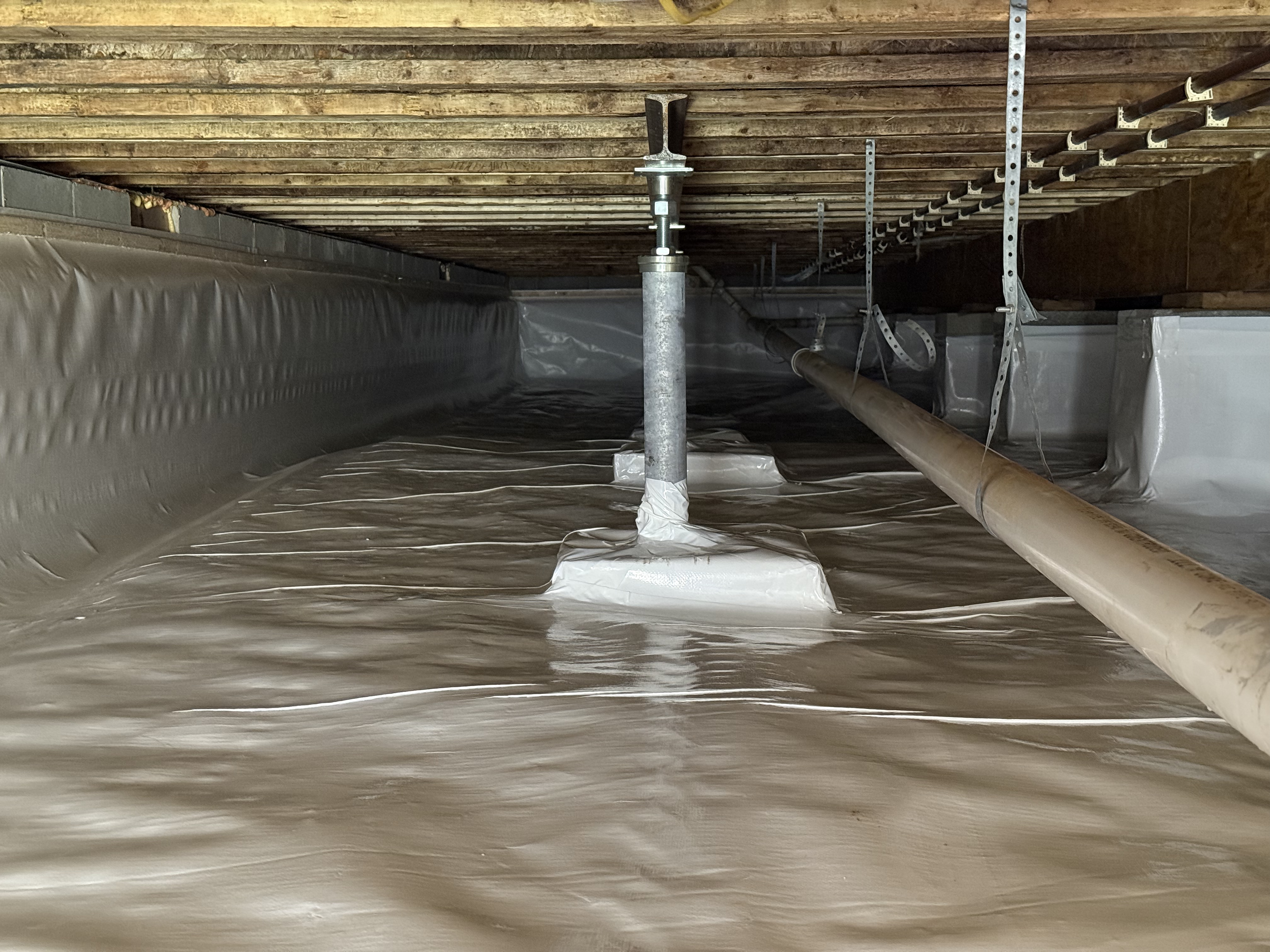 Sealed crawlspace access window with white vapor barrier during encapsulation, Chattanooga TN
