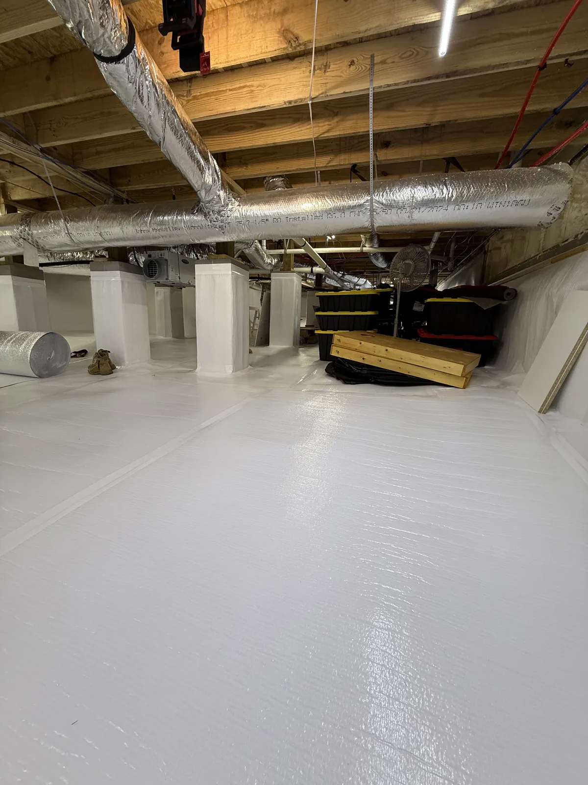 Finished crawlspace encapsulation with bright white vapor barrier floor, wrapped support columns and insulated HVAC ductwork, Chattanooga TN