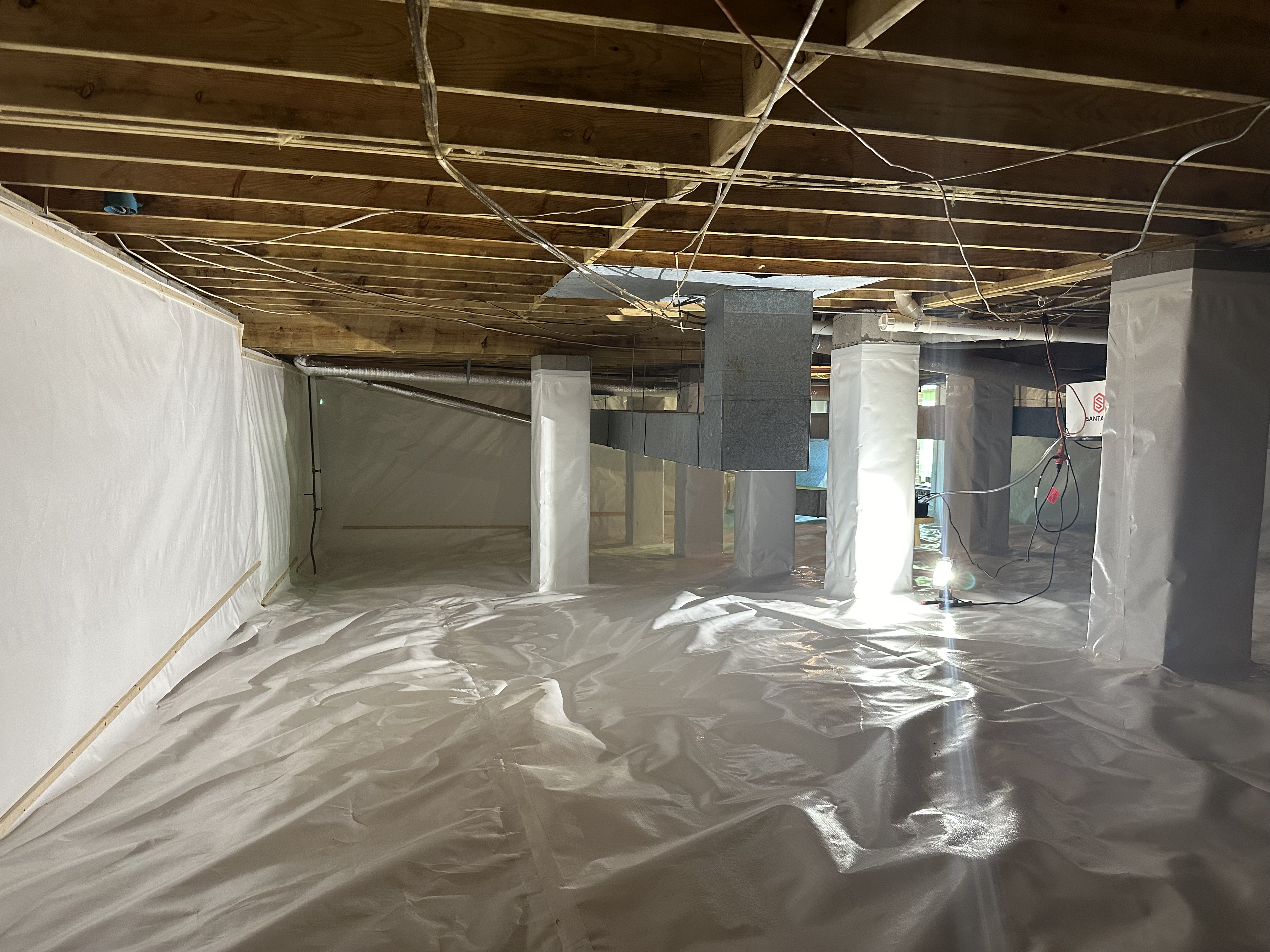 Santa-Fe dehumidifier wall-mounted in gray vapor barrier encapsulated crawlspace, Chattanooga TN moisture control